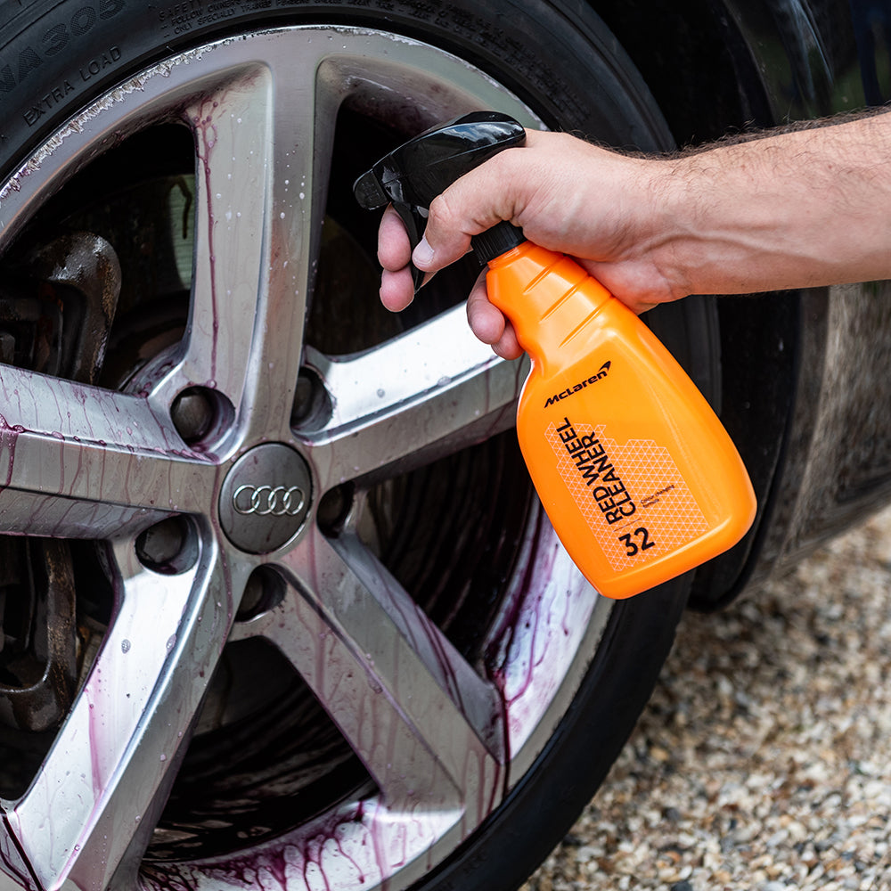 mclaren red wheel cleaner sprayed on car wheel